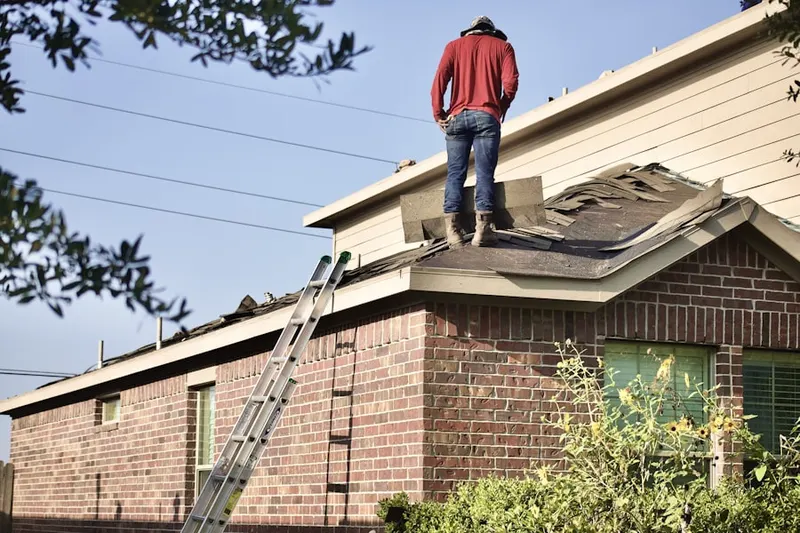 Professional roofer working on a residential roof in Shamrock Estates